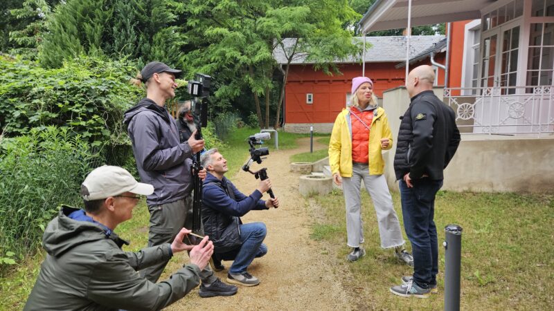 Der rbb zu Gast in Hangelsberg: Zu Wochenbeginn hat das Heimatjournal-Team mit Moderatorin Ulrike Finck den Grünheider Ortsteil aufgesucht. Matthias Schielke (rechts), Mit-Eigentümer der „Roten Villa“, durfte von der Geschichte des ortsbildprägenden Gebäudes erzählen. Foto: Anke Beißer.
